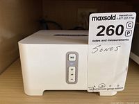 Front view of white Sonos Connect showing play/pause and volume buttons