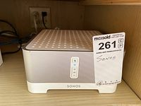 Front view of Sonos Connect:Amp showing volume and mute buttons, with MaxSold tag attached.