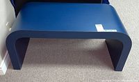 Front view of the blue laminate waterfall leg table