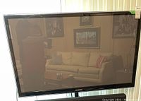 Front view of Samsung plasma TV turned off, showing large screen and bezel.