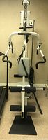Front view of gray Precor Pacific Fitness Zumba home gym machine showing seat and handles
