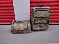 Front view showing both luggage pieces side by side with beige patterned fabric and brown trim