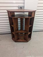 Front view of the solid wood corner unit bookshelf showing its octagonal shape and multiple shelves.