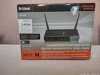 Front view of D-Link DIR-628 router box showing router image and key features like 5GHz and 2.4GHz dual band support.