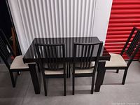 Front view of the full set showing table and four chairs arranged.