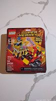 Front of Lego Marvel Super Heroes Mighty Micros box showing 94 pieces and set number 76072 with art of Thanos and Iron Man mini-vehicles and figures.