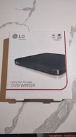 Front of the box showing LG logo, product image of the ultra slim portable DVD writer, and compatibility with Windows and Mac OS.
