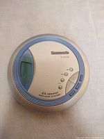 Top view of the Panasonic SL-SX330 Discman showing buttons and branding on the lid.