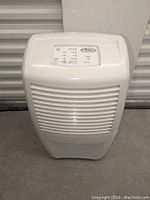 Full view of the Whirlpool dehumidifier showing front vent grille and overall condition.