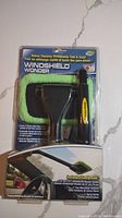 Full view of Windshield Wonder car window scraper cleaner in original packaging showing product and included items.