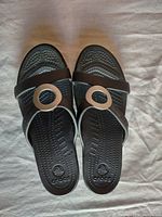 Top view of women's black Crocs sandals showing straps and decorative round rings