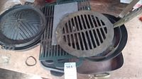 Set of cast iron kitchenware including grilling plates, a skillet, a round pan and cooking grate with handle, showed stacked and arranged