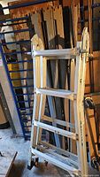 Werner aluminum extension ladder leaning against wall, showing overall condition and several rungs.
