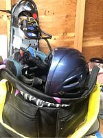 Winter helmet and gloves inside a zippered bag with visible brand text