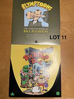 Photo of two laser discs - 'The Complete Works of Bill Plympton' and 'The Rocketship Reel' laid flat on wooden surface