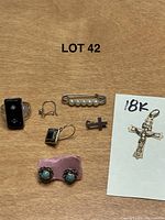 Overview of all eight jewelry pieces on wood surface