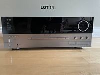 Front view of Harman Kardon AVR-335 receiver showing buttons, knobs, and display