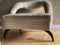 Front view of the chair showing upholstery texture and leg design.
