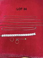 Top view of all jewelry pieces laid on red cloth