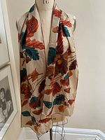 Scarf draped over a mannequin displaying full length and pattern details against a neutral background.