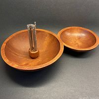 Overview of large and smaller solid maple bowls with central utensil holder and three nut cracking utensils