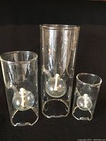 Set of three WOLFARD hand blown glass oil lamps arranged side by side showing size variations.