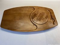 Full view of the maple cheeseboard showing overall shape, circular built-in cheese section, and cracker indentations.