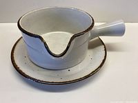 Gravy boat set on matching saucer, showing cream ceramic with chocolate speckled pattern and chocolate rim, classic 60s style