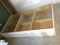 Top view of captains bed base showing compartments inside and three drawers on the side