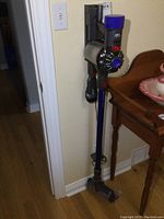 Vacuum assembled on wall-mount bracket showing overall setup