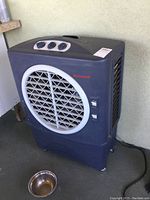 Front view of large Honeywell evaporative cooler fan with control knobs and front vent grille.