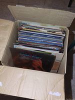 Cardboard box packed with upright LP sleeves