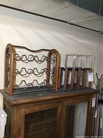 Photo showing all three wine racks on a wooden surface against a wall