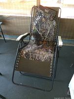 Front view of the Timber Ridge zero gravity chair with camouflage fabric and padded armrests.