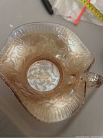 Top view of the carnival glass bowl showing iridescence and floral pattern inside.