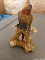 Ceramic bud vase showing front view of bird on branches design atop the vase. The vase height is visible showing approximately 6 inches.