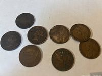 Photo showing all 8 coins arranged in two rows, highlighting the variety of dates and wear.