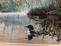 Close-up of the detailed loon artwork in natural environment