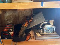 Photo showing the three power tools together: Dormeyer circular saw in metal case, Rigid reciprocating saw, Black & Decker jigsaw in box.