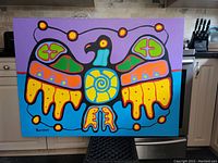 Full front view of acrylic thunderbird painting with purple and turquoise backgrounds