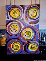 Front view of the original oil painting featuring six colorful spiral designs.