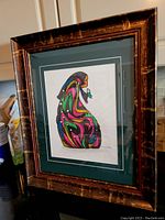 Framed original acrylic painting by Don Chase leaning on a surface, showing full artwork and frame.