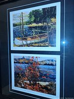 Close view of both Tom Thomson prints in the frame showing titles and signatures