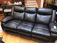 Full front view of dark brown leather three-seat sofa in upright position