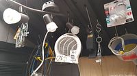 Wide view showing heater, funnel, light fixture, bungee cord, and bulb