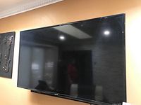 Front view of mounted TV with sound bar beneath