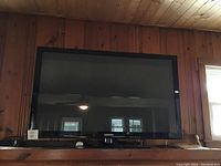 Front view of the Samsung TV showing the screen and bezel.