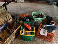 Overview of baskets filled with various hand tools and decorative drawer knobs scattered around