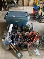Full view of all tools and storage tote with items spread out in front.
