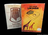 Two original boxed African musical hand harps, Kalimba and Likimba side by side